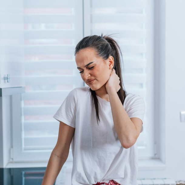 Woman holding her neck in pain