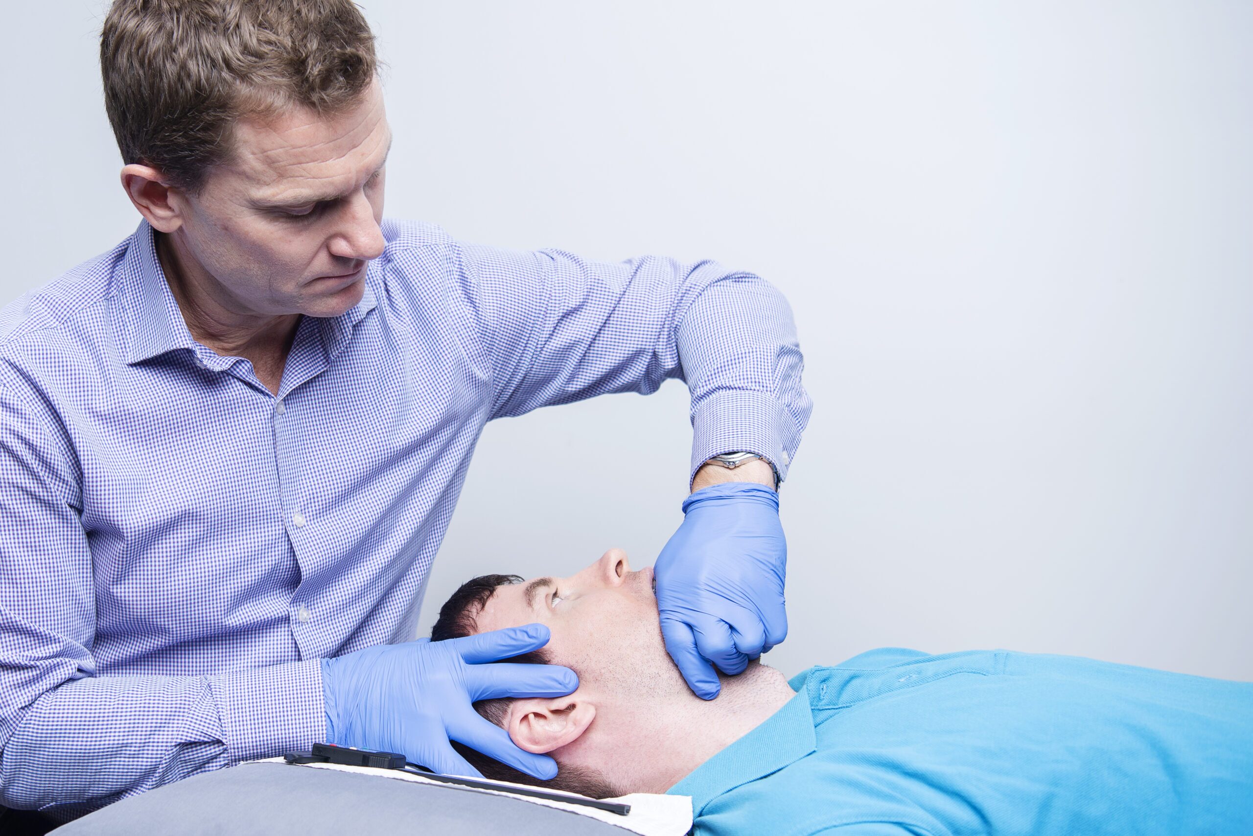 Headache Neck and Jaw Clinic physio Scott Cook treating TMJ condition