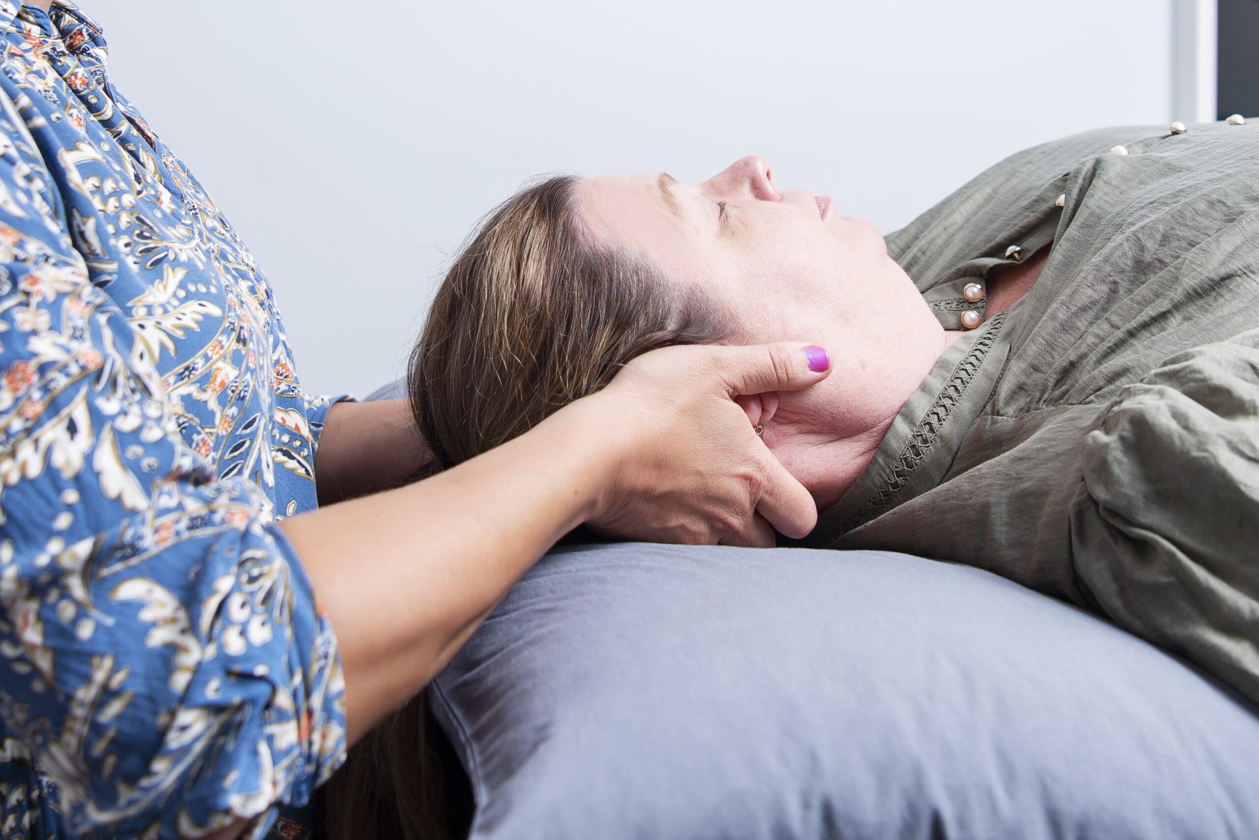 Female physio treating migraine symptoms