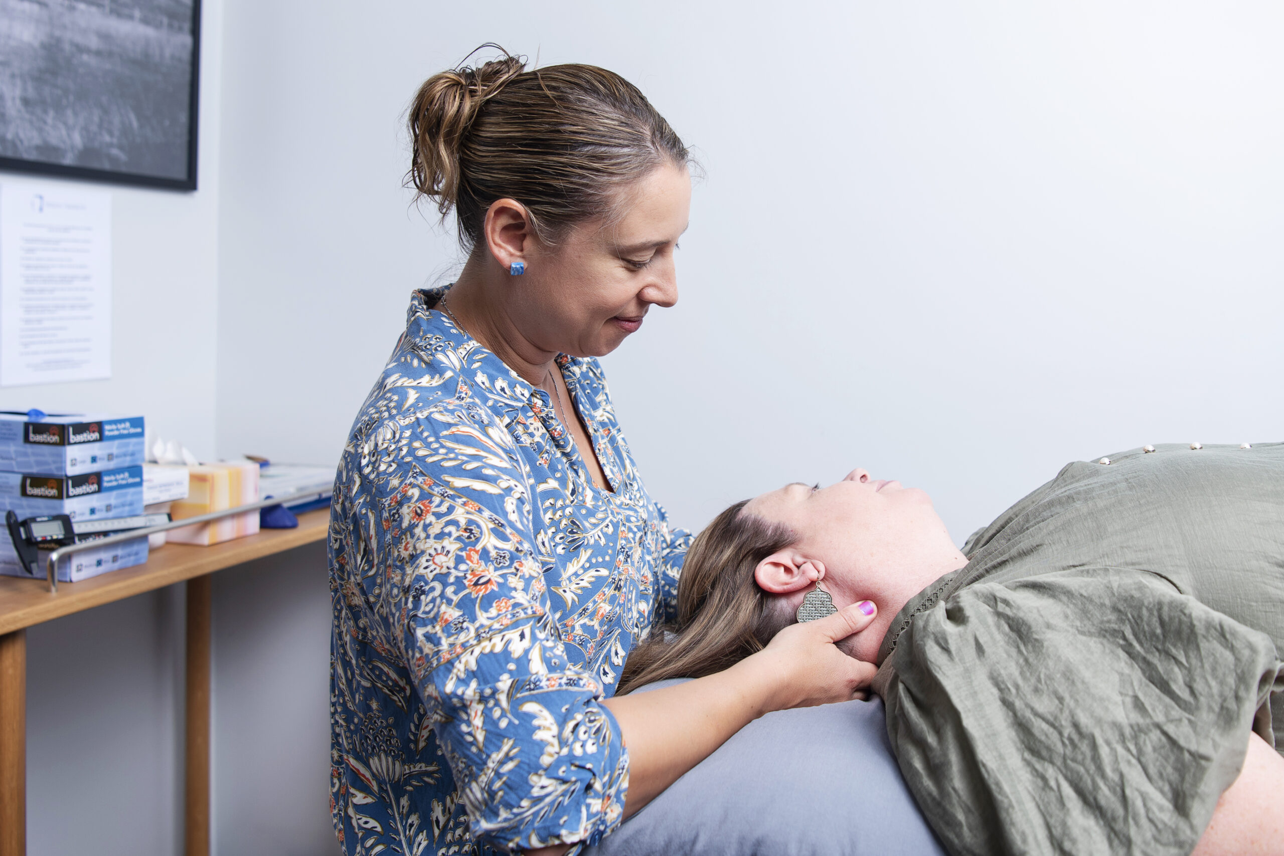 Physiotherapist treating patient with whiplash