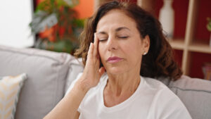 middle aged woman experiencing dizziness caused by silent migraine