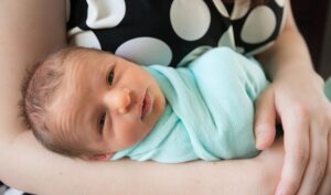 newborn baby in mothers arms
