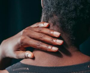 lady holding back of neck